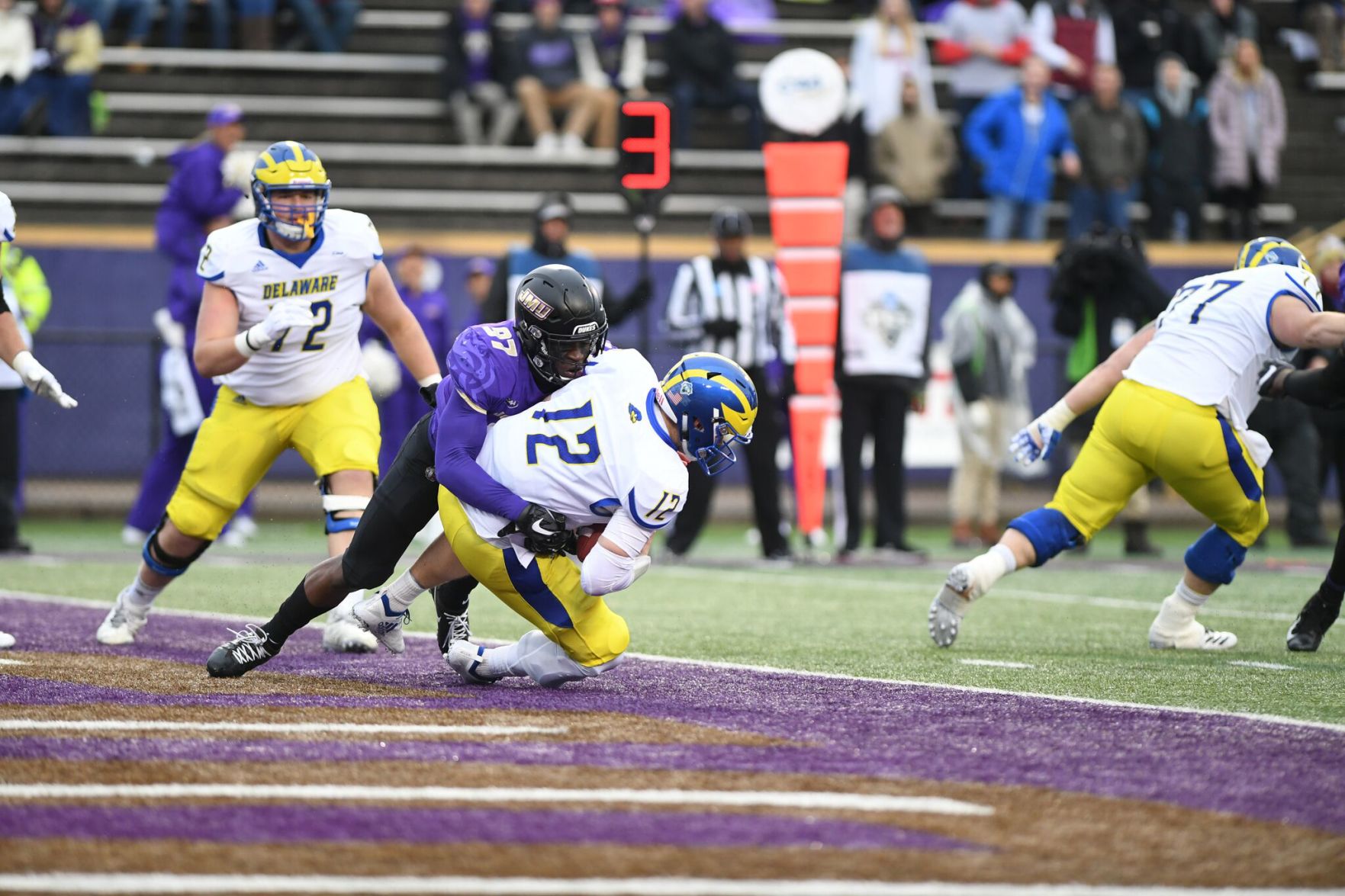 Delaware's Pat Kehoe is sacked by James Madison's John Daka for a safety